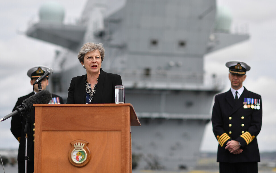 Then-UK Prime Minister Theresa May speaks on the flight deck to crew members of the British aircraft carrier HMS Queen Elizabeth in Portsmouth on Aug. 16, 2017. (Reuters)