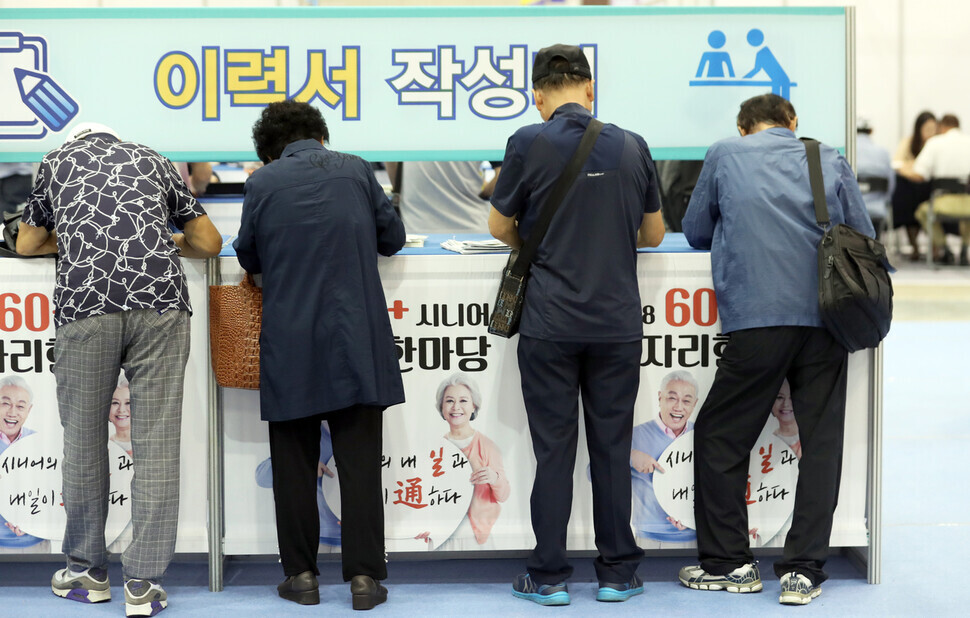Older Koreans fill out resumes at a booth at the “60+ Senior Job Fair” held at the Busan Exhibition and Convention Center in the southeastern city’s Haeundae District. (Yonhap)