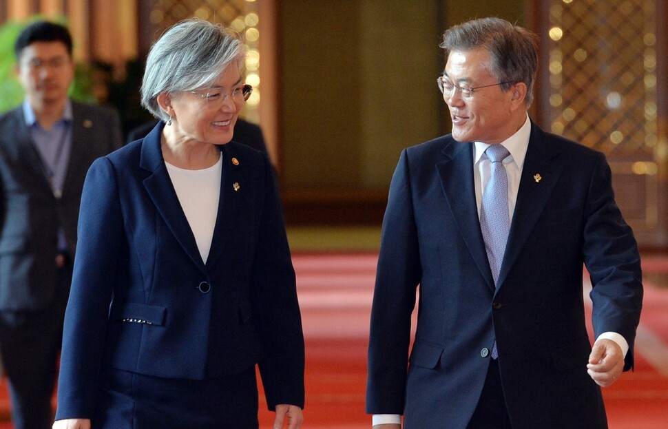 South Korean President Moon Jae-in and Foreign Minister Kang Kyung-hwa enter a meeting with former South Korean ambassadors to the US