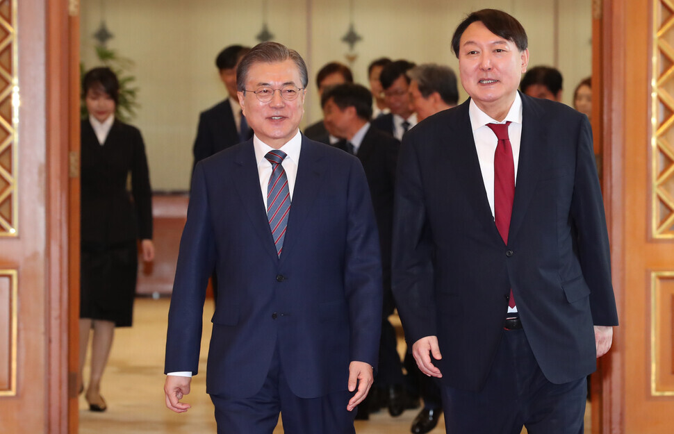 President Moon Jae-in walks alongside then-Prosecutor General Yoon Suk-yeol following Yoon’s appointment ceremony on July 25, 2019. (Blue House pool photo)