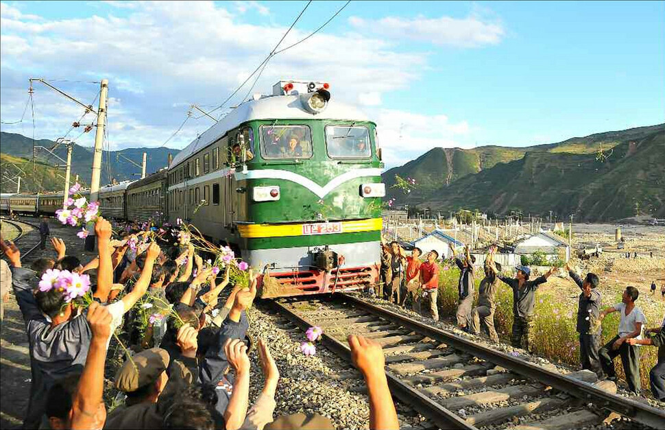 The first train on the route from Komusan Station since recent flooding hit and tracks were repaired