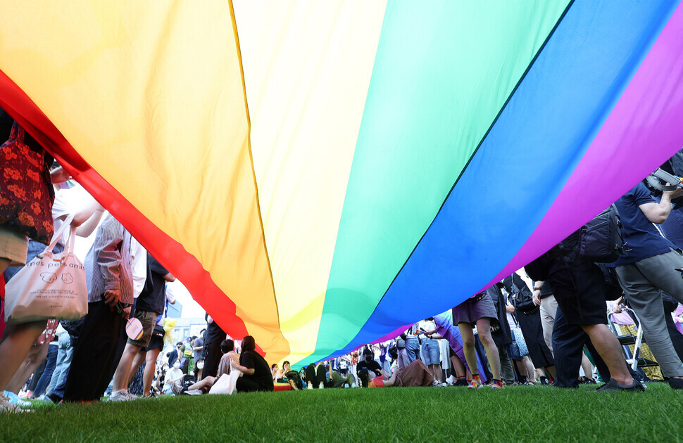A massive rainbow flag flies over Seoul Plaza on July 16 during the 2022 Seoul Queer Culture Festival. (Yonhap News)