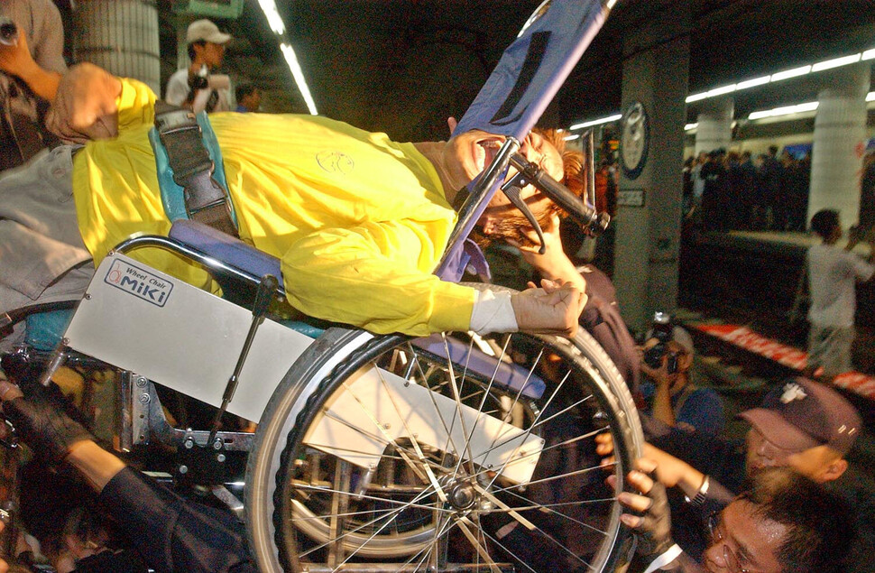 2002년 9월11일 서울 지하철 1호선 시청역 선로 점거투쟁에 나선 장애인이동권연대 회원이 경찰에 의해 옮겨지고 있다. 장애인 이동권 투쟁은 20년 넘게 이어져왔다. 연합뉴스