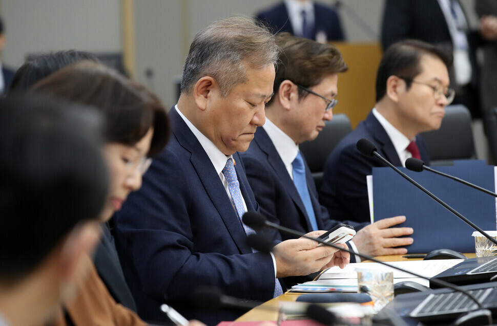 Safety and Interior Minister Lee Sang-min checks his phone while attending a Cabinet meeting at the government complex in Sejong on Feb. 4. (presidential office pool photo)