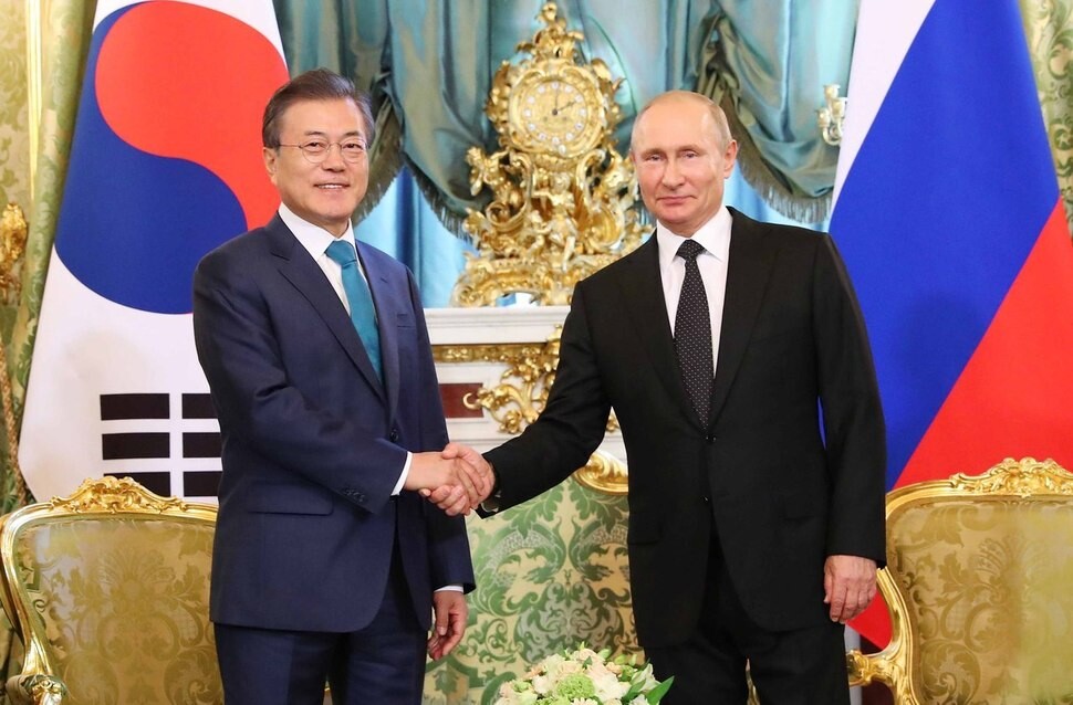 South Korean President Moon Jae-in shakes hands with Russian President Vladimir Putin during a smaller summit at the Grand Kremlin Palace in Moscow on June 22. (Yonhap News)