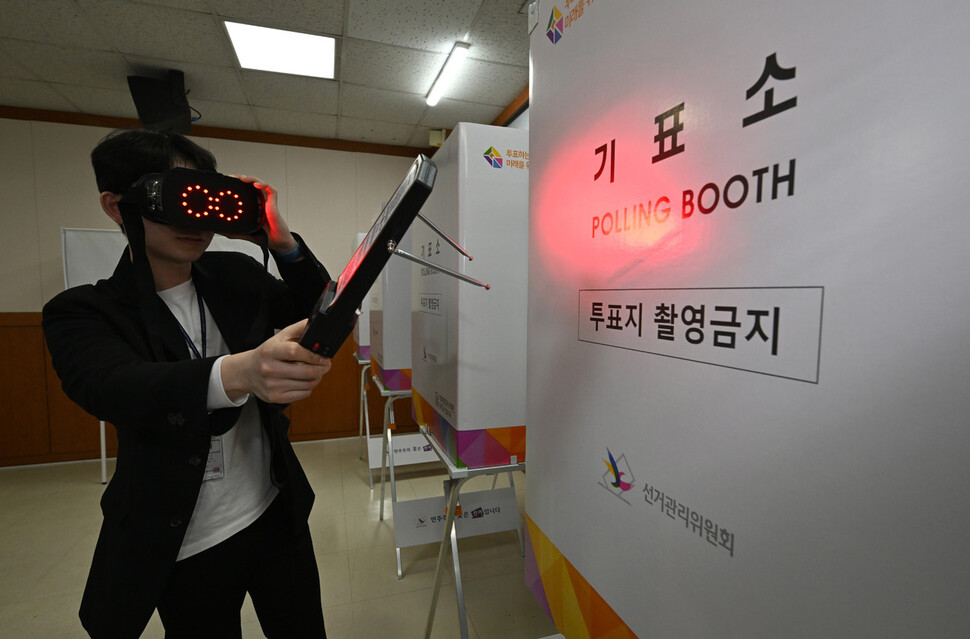 선거관리위원회 직원이 2024년 4월4일 서울 삼성2동 주민센터에 마련된 사전투표소에서 몰래카메라 설치 여부를 점검하고 있다.