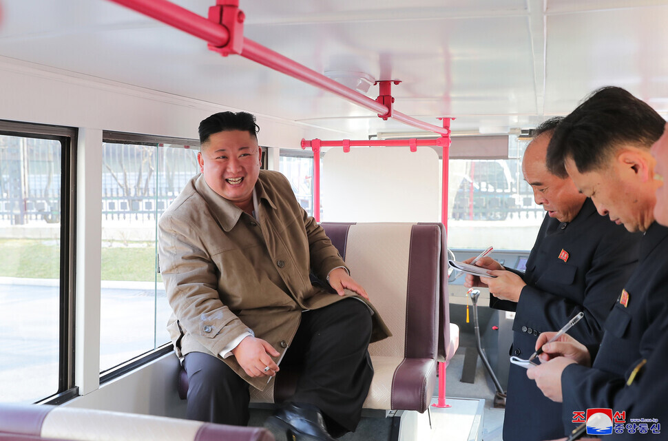 North Korean leader Kim Jong-un sits inside a prototype of a passenger bus in Pyongyang on March 25, 2021. Kim did not oversee the launch of a new type of missile that the North conducted the same day. (Yonhap News)