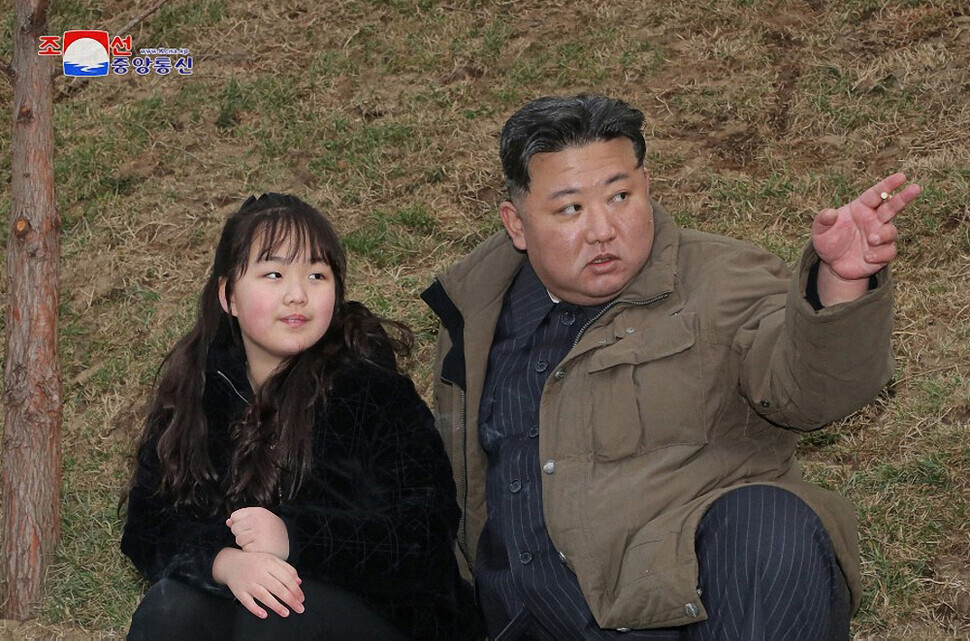 State media on April 13 released this photo of Kim Jong-un, the leader of North Korea, as he “guided the first test-fire of the new-type ICBM” it called the Hwasong-18. His daughter, Kim Ju-ae (left), accompanied him at the launch. (KCNA/Yonhap)