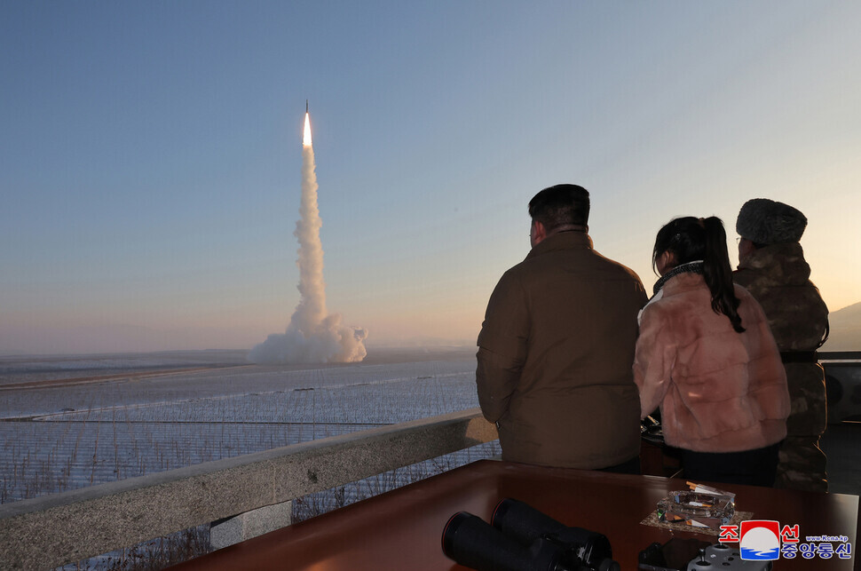 This photo, released by North Korean state media, shows North Korean leader Kim Jong-un joined by his daughter, Kim Ju-ae, as he watches the launch of the Hwasong-18 solid-fuel ICBM on Dec. 18. (KCNA/Yonhap)