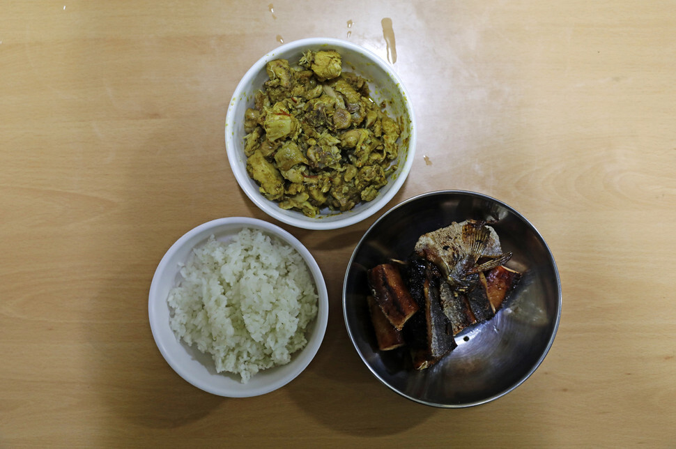 A simple Cambodian meal of chicken curry, dried pollack, and rice