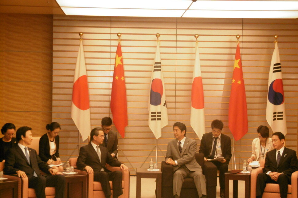 Japanese Prime Minister Shinzo Abe (front