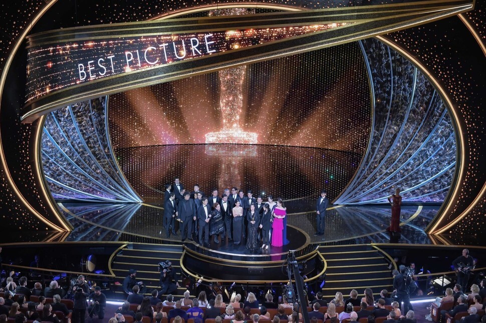 South Korean filmmaker Bong Joon-ho accepts the Academy Award for best picture along with the cast and production crew of “Parasite” in Los Angeles on Feb. 9.