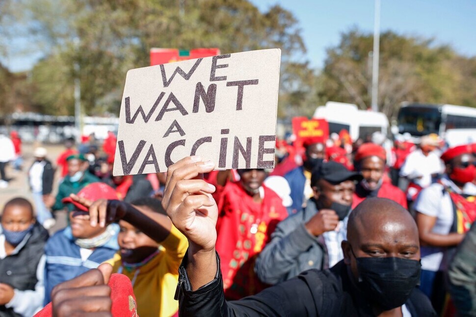A protester in Pretoria, South Africa, holds up a sign that reads, 