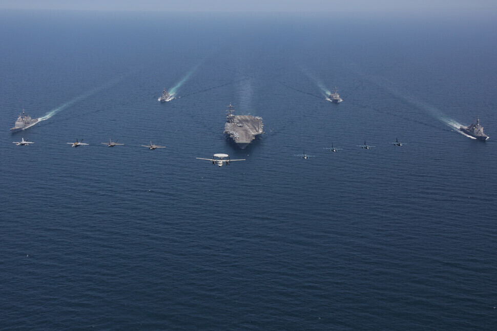 The USS Abraham Lincoln aircraft carrier navigates the East Sea with vessels from the US and Japanese Maritime Self-Defense Force on April 13, 2022. (provided by the US 7th Fleet)