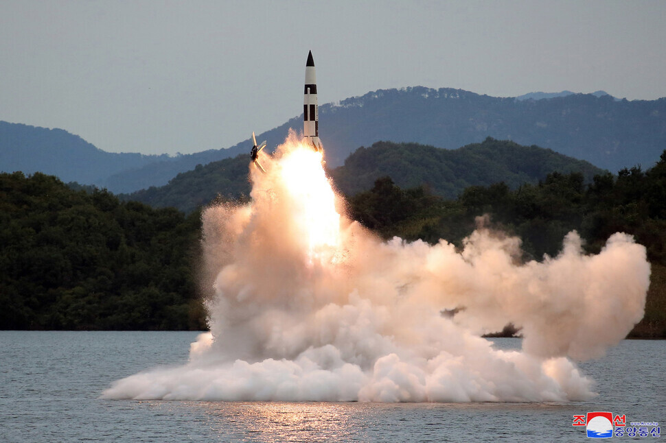 This photo, released by North Korean state media, shows what Pyongyang claimed to be an exercise launching a ballistic missile with a dummy tactical nuke on board from a reservoir on Sept. 25. (KCNA/Yonhap)