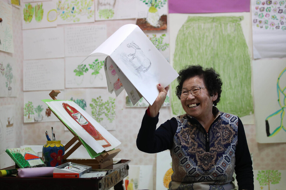 홍태옥 할망(86)이 자신의 집 그림방에서 최근에 혼자 그려보았다는 말그림을 들고 환하게 웃고 있다. 백소아 기자