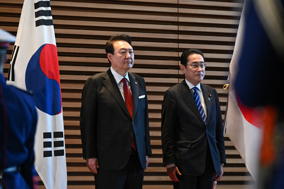 President Yoon Suk-yeol of Korea and Prime Minister Fumio Kishida of Japan stand for their respective national anthems during a welcome ceremony at the prime minister’s residence in Tokyo on March 16. (Yonhap)