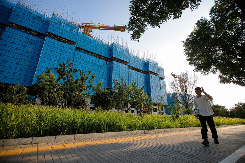A person walks by a Country Garden construction site in Beijing on Aug. 14. (EPA/Yonhap)