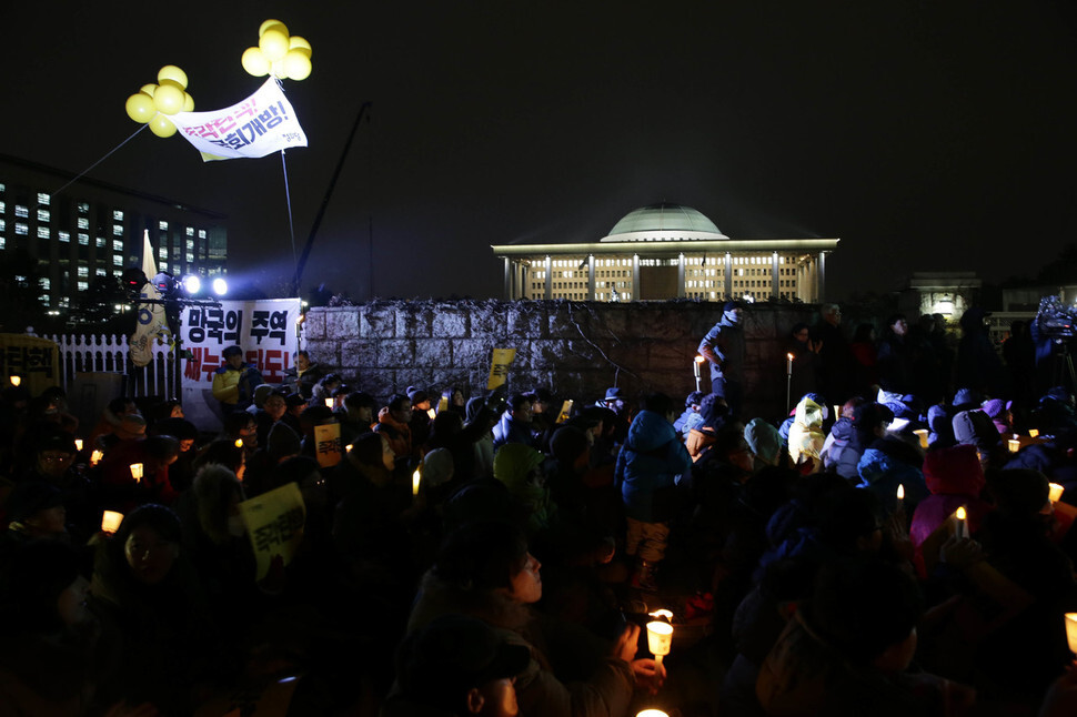  members of the opposition Minjoo Party hold a candlelight demonstration on the steps to the National Assembly main hall