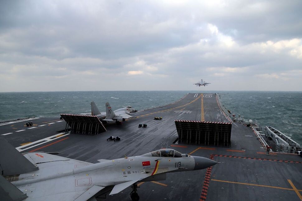 Chinese J-15 fighter jets take off from the deck of the Liaoning aircraft carrier during military drills on Dec. 23