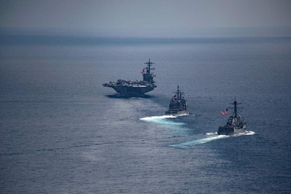 The USS Carl Vinson (left) in the waters off Indonesia