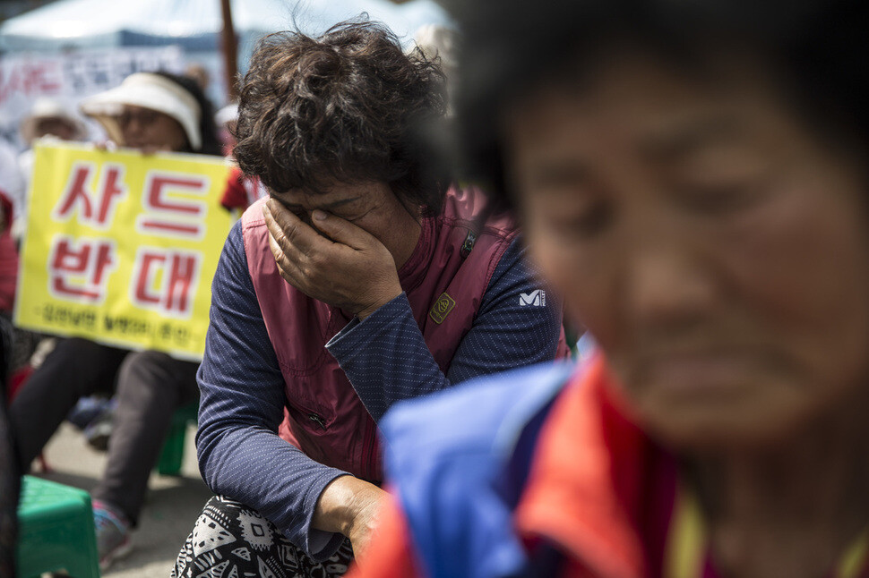Local residents cry while protesting the deployment of the THAAD missile defense system in Seongju