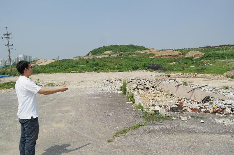 A Seoul Housing and Communities Corporation staff member points at the site of a former US military base