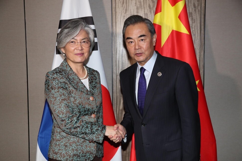 South Korean Foreign Minister Kang Kyung-wha shakes hands with Chinese Foreign Minister Wang Yi before their meeting at the ASEAN Regional Forum (ARF) foreign ministers’ meeting in Manila