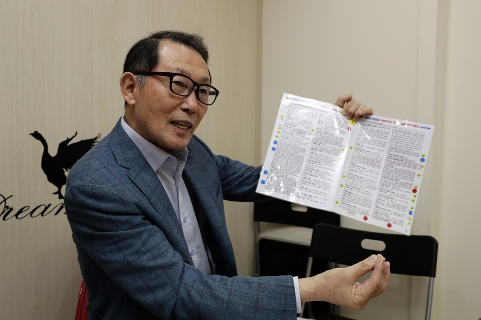 Kim Cheok explains a set of documents relating to his son’s case while visiting the Hankyoreh office in the Gongdeok neighborhood of Seoul on Aug. 31.  (by Kim Myoung-jin