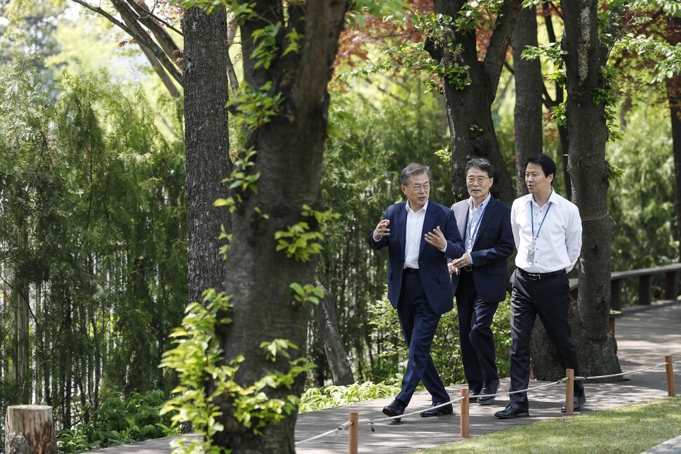 President Moon walks in the presidential garden with Im Jong-seok