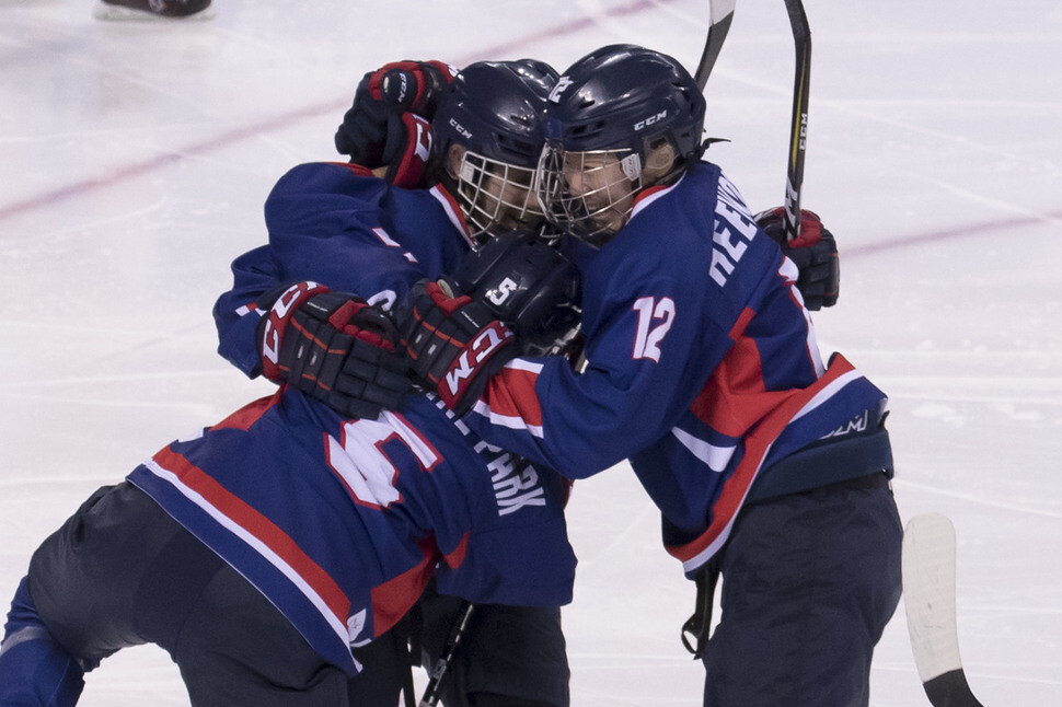 Randi Heesoo Griffin is joined by her teammates on unified Korean women’s hockey team after scoring a goal against Japan during the 2018 Pyeongchang Olympics on Feb. 14 in Gangneung