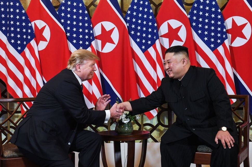 North Korean leader Kim Jong-un and US President Donald Trump greet each other at the Sofitel Legend Metropole Hanoi hotel on the evening of Feb. 27. (AFP/Yonhap News)