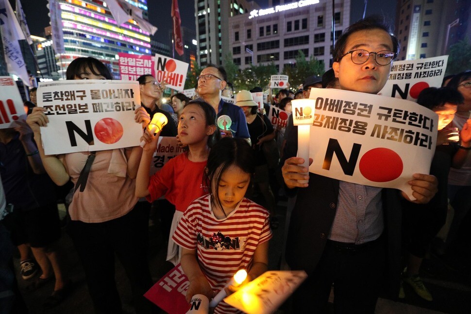 South Korean demonstrators hold a candlelit rally in opposition to Japanese Prime Minister Shinzo Abe in Seoul on Aug. 3. (Kim Bong-gyu