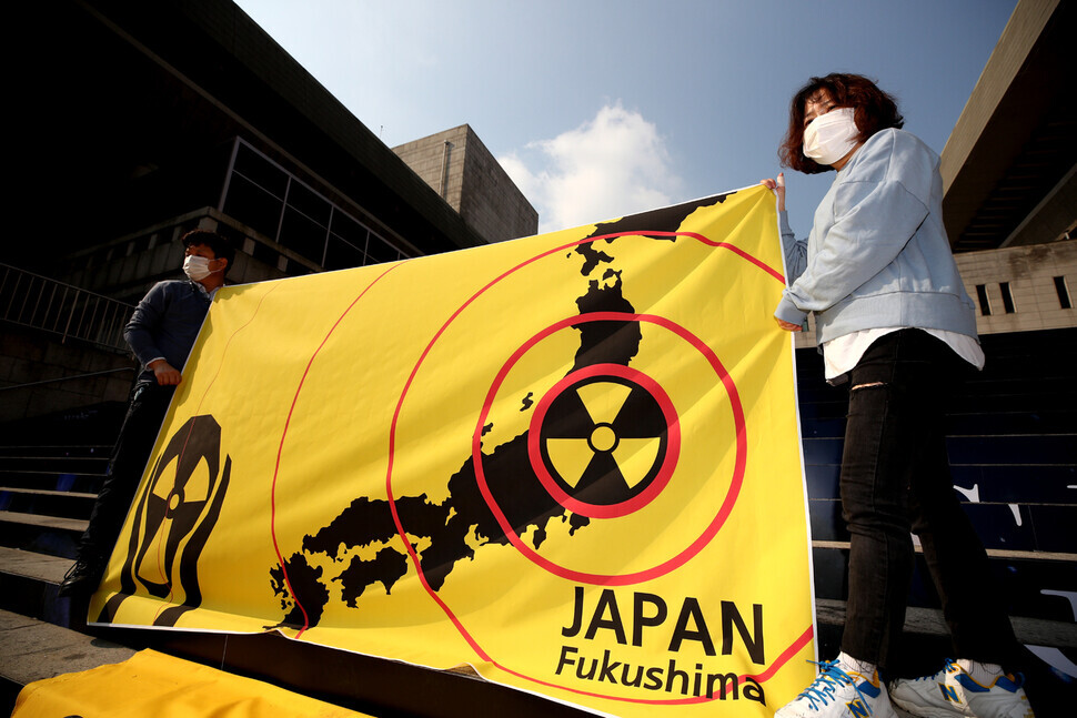 Demonstrators hold up a banner expressing their opposition to Japan’s plan to release radioactive water from the Fukushima power plant into the Pacific Ocean.
