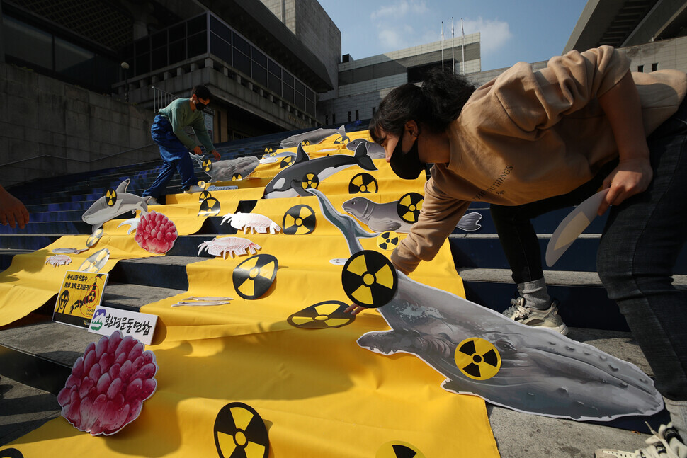 Demonstrators display images of marine wildlife that would be harmed by the radioactive water.