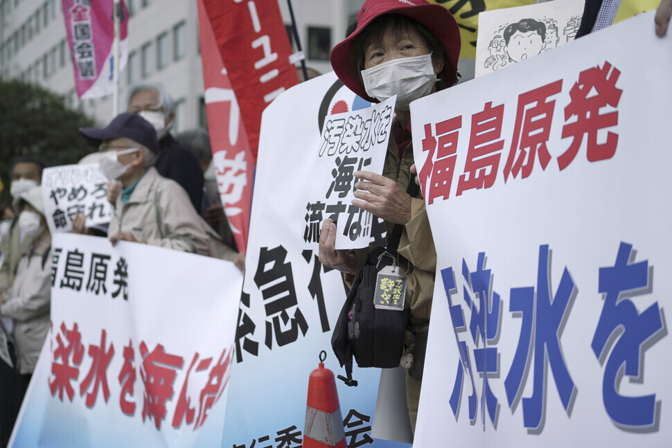 Japanese citizens Tuesday protest the Japanese government's decision to release the contaminated water from the Fukushima nuclear power plant into the sea, outside the prime minister's office in Tokyo. (AP/Yonhap News)