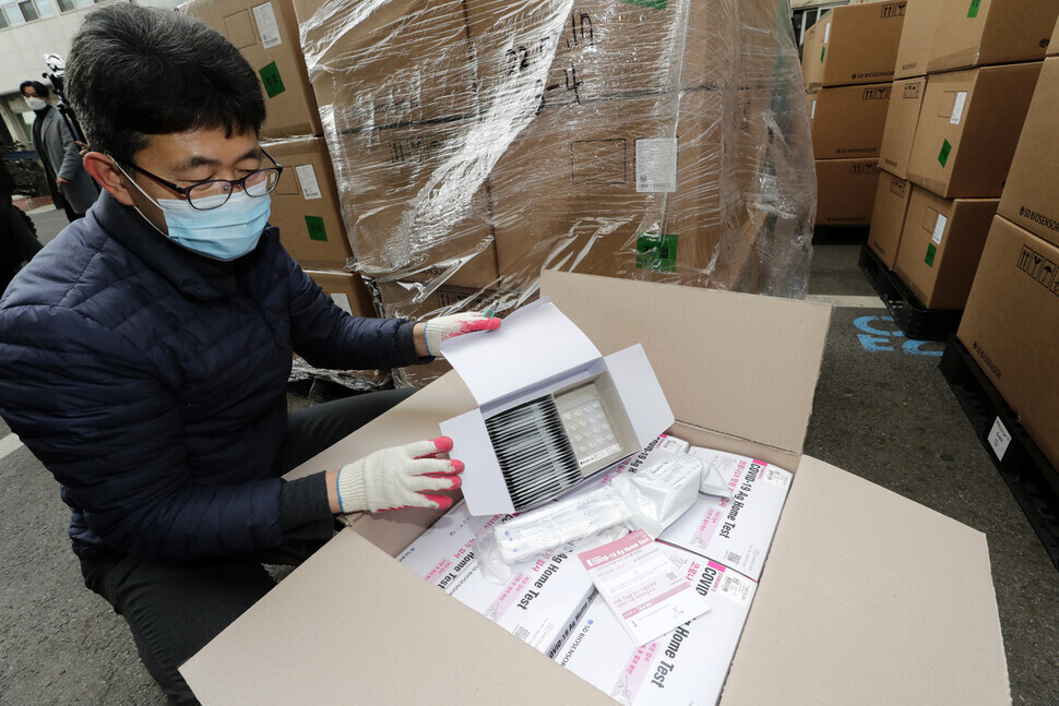 A staff member at the Seoul Metropolitan Office of Education checks a box of COVID-19 home tests. (Kim Myoung-jin/The Hankyoreh)<b><br><br></b>