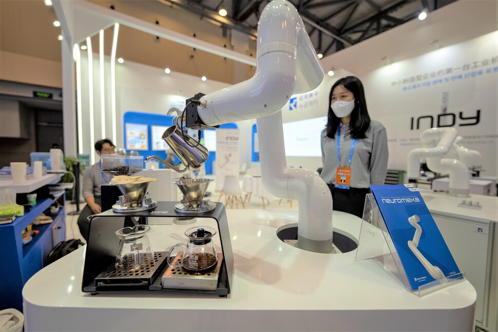 2021年10月29日に江蘇省塩城市で開催された第3回韓中貿易投資博覧会の展示ホールで、参加企業が開発したロボットアームがコーヒーを淹れています。張海峰（張凱峰）/人物写真