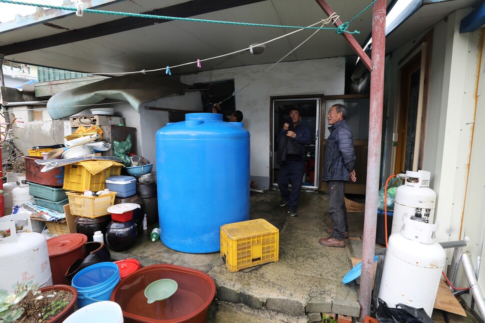 금일도 주민 서성홍(63·오른쪽 둘째)씨가 언제 해소될지 모를 가뭄에 대비해 100만원(모터와 설치 비용 포함)이 넘는 물탱크를 마당에 설치하고 있다.