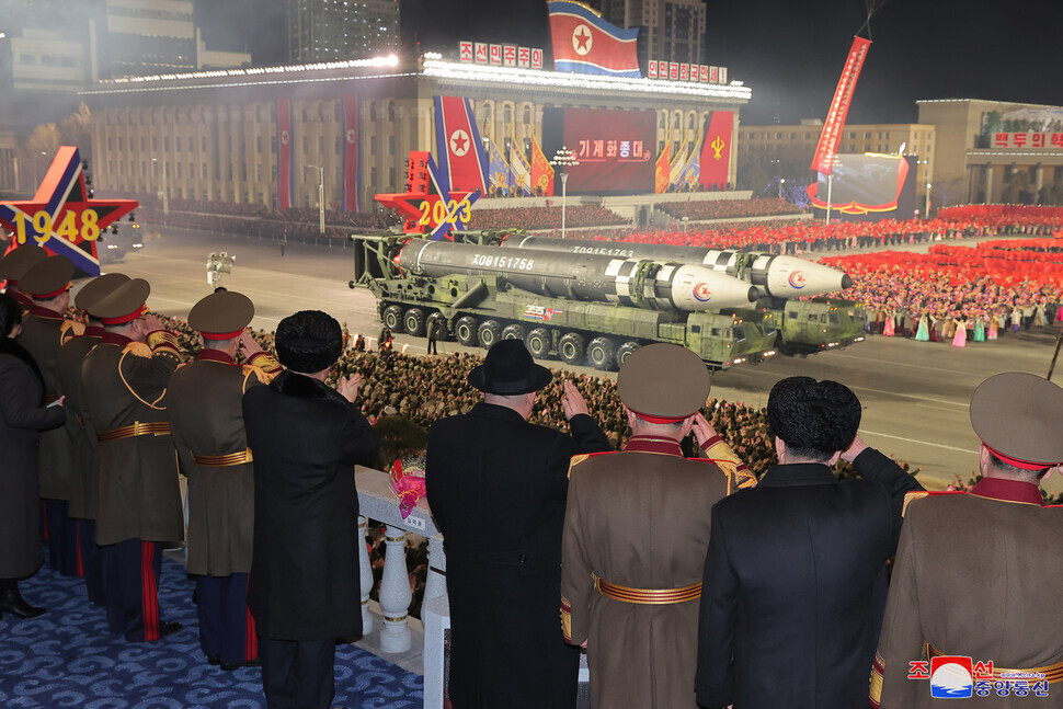 North Korean leader Kim Jong-un watches Hwasong-17 ICBMs be showcased during the nighttime military parade in Pyongyang’s Kim Il-sung Square held for the 75th founding anniversary of the Korean People’s Army on Feb. 8. (KCNA/Yonhap)