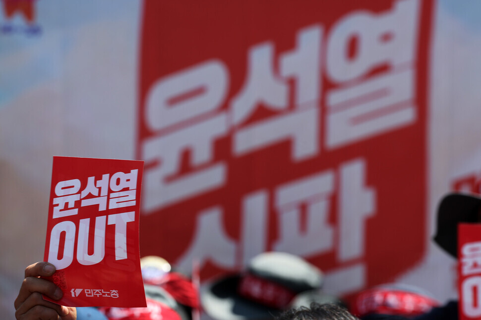 On May 1, International Workers Day, members of the Korean Confederation of Trade Unions held a May Day rally in the heart of Seoul. A participant is seen here holding a sign that reads “Out with Yoon Suk-yeol.” (Kim Hye-yun/The Hankyoreh)