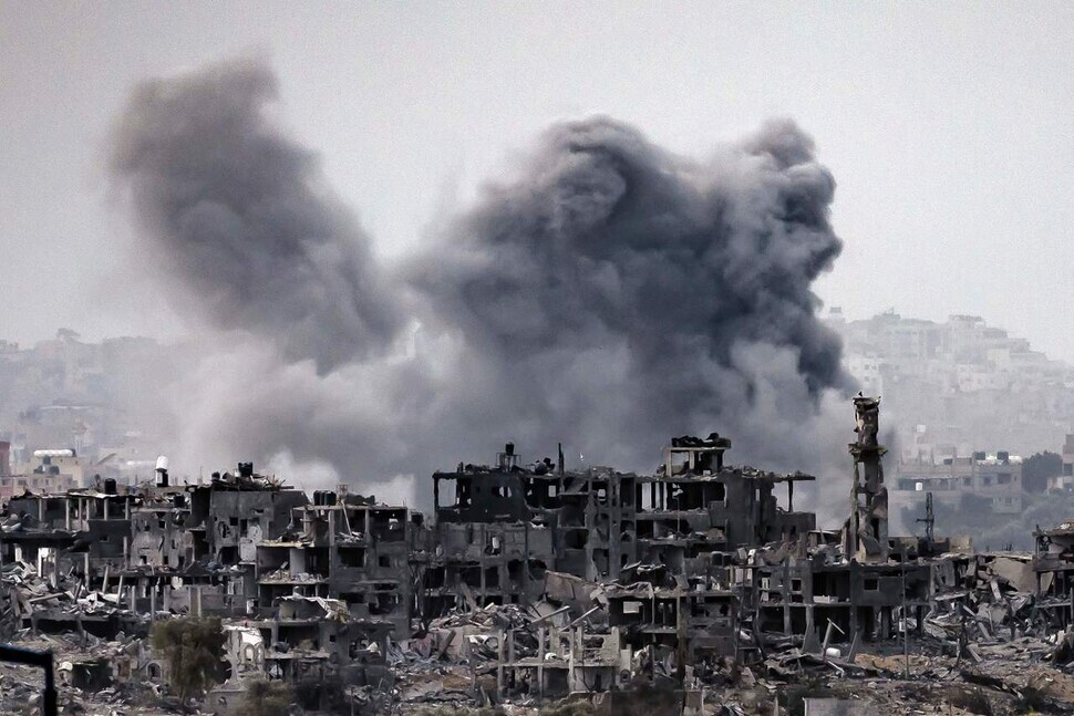 Smoke rises from the ruins of buildings in Gaza following Israeli bombing on Nov. 12. (AFP/Yonhap)