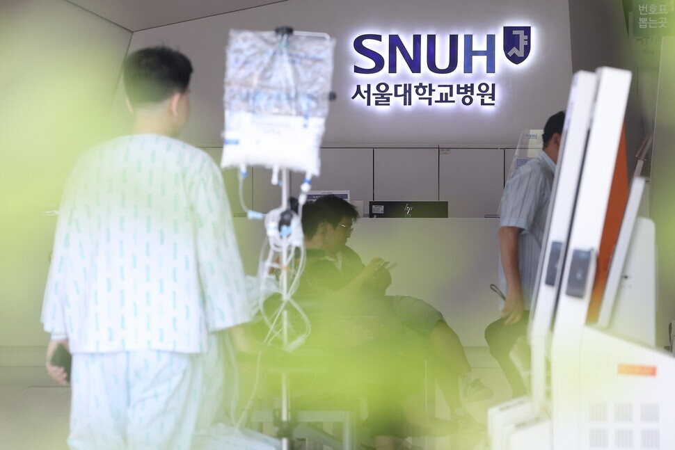 Patients walk through the lobby at Seoul National University Hospital in Seoul’s Jongno District on June 16, 2024. (Yonhap)