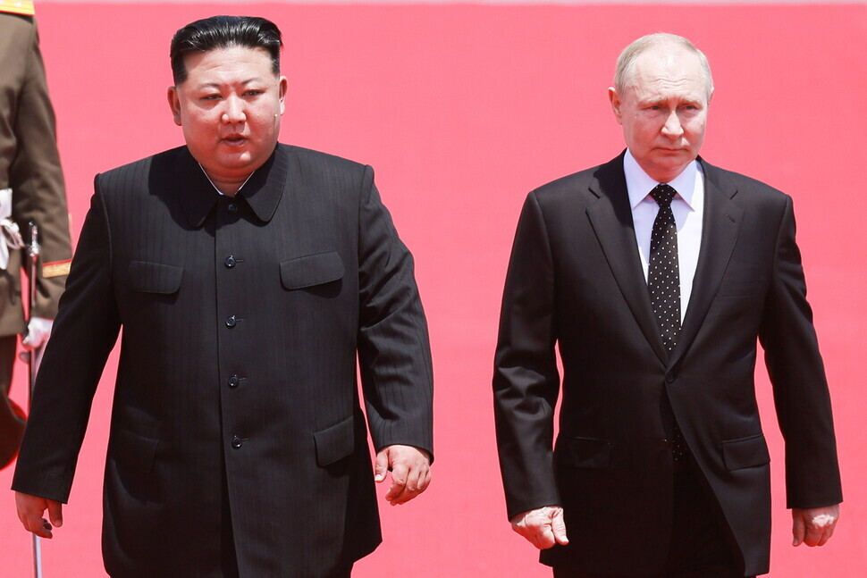 North Korean leader Kim Jong-un and President Vladimir Putin of Russia walk side-by-side at a welcome ceremony for Putin and his delegation held at Kim Il-sung Square in Pyongyang, North Korea, on June 18, 2024. (Reuters/Yonhap)