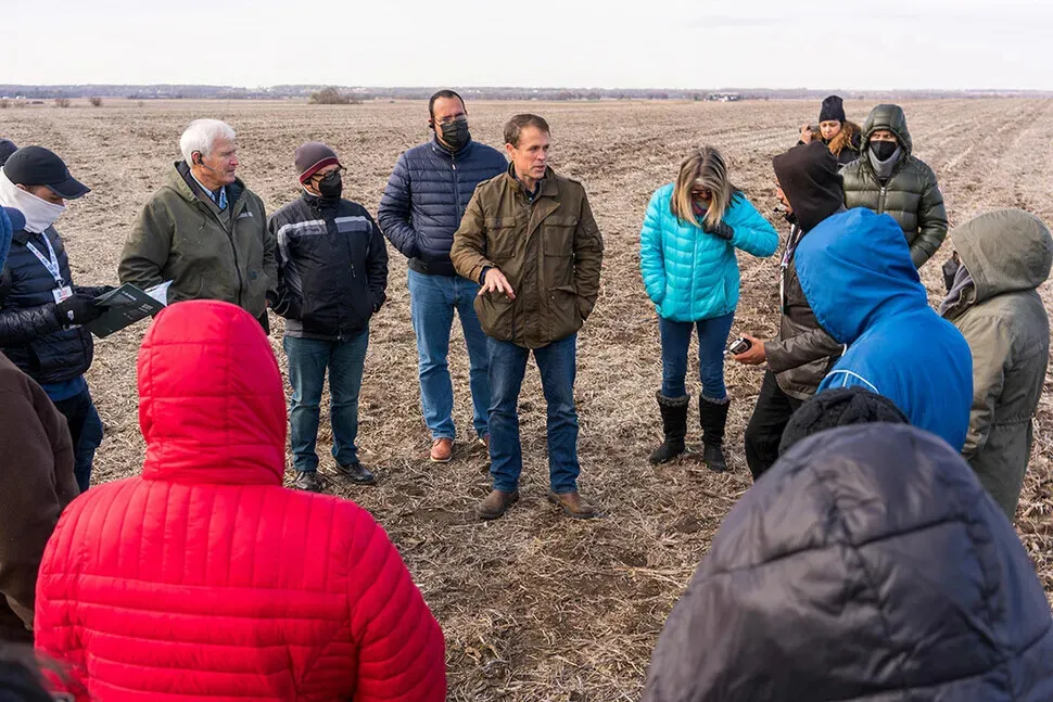Grant Kimberley (center) speaks to a South American delegation visiting his farm as part of a US-South America trade exchange program put on by the Iowa Soybean Association in November 2021. (courtesy of the Iowa Soybean Association)