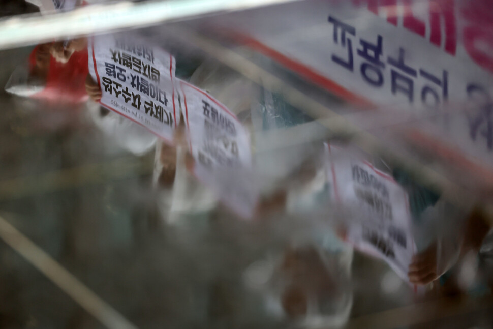 전교조·차별금지법제정연대·청소년성소수자지원센터 띵동·무지개행동 등 132개 인권시민사회단체가 1일 오전 광화문광장에서 기자회견을 열어 교육부의 ‘혐오·차별 표현 대응 가이드북’에서 성소수자 관련 내용을 삭제한 것을 비판하고 이를 복구할 것을 요구하는 가운데 이들의 모습이 빗물에 비치고 있다. 김영원 기자