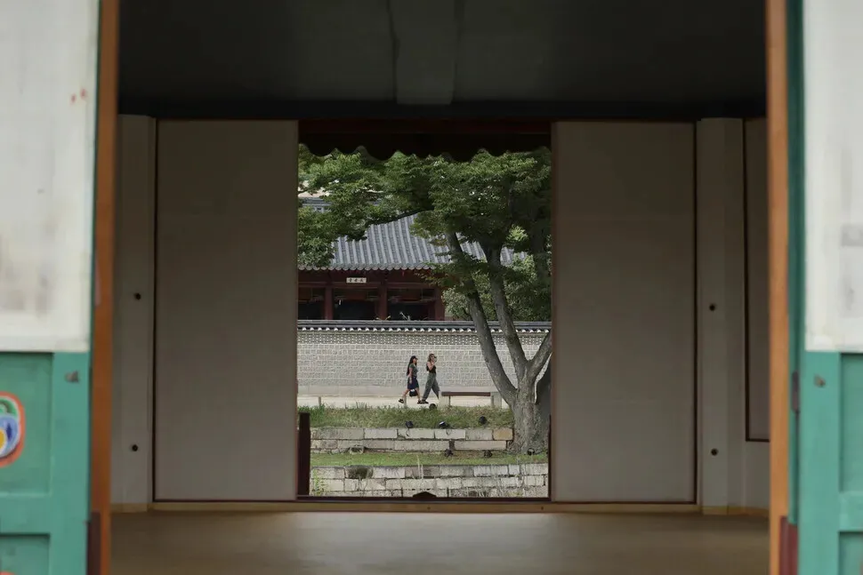 Tourists walk through Gyeongbok Palace as seen from Hyangwon Pavilion on Sept. 2, 2026. (Choi Hyeon-su/Hankyoreh)
