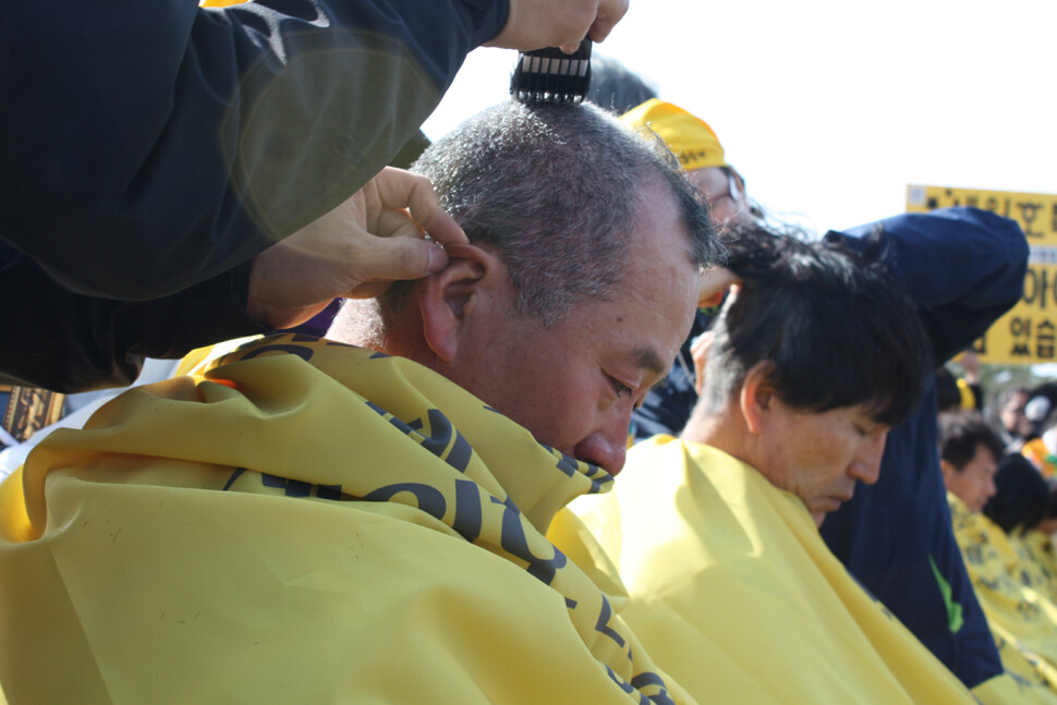 Families of victims of the Sewol ferry sinking pass a park while marching from the government memorial altar in Ansan