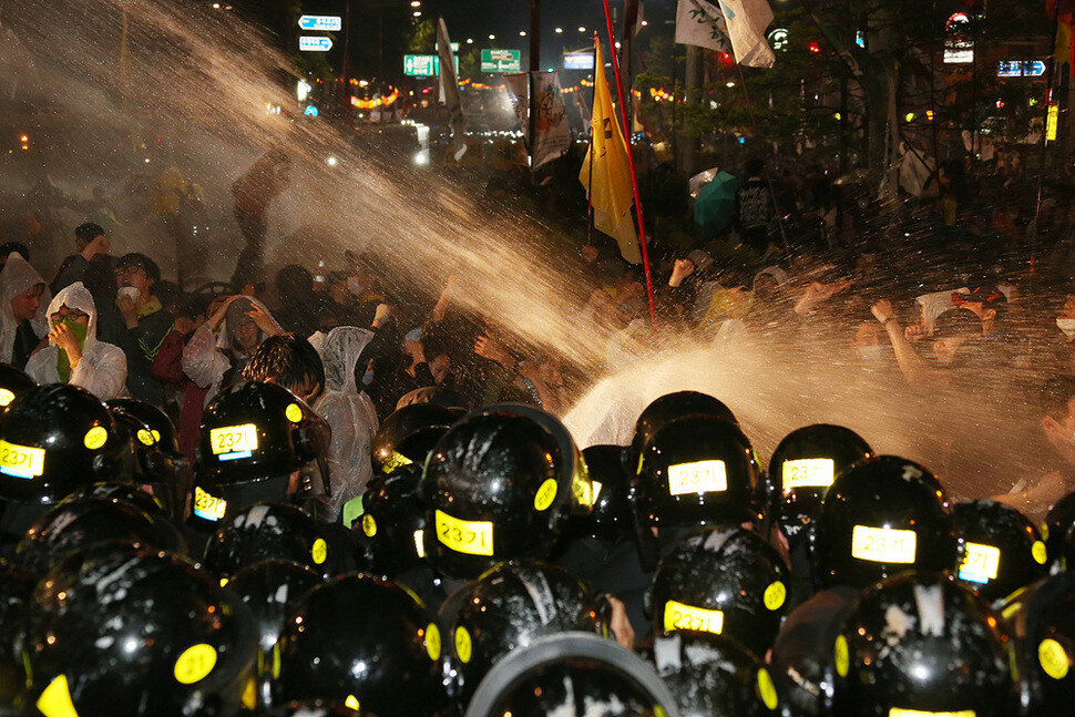  while spraying them with water and tear gas at Anguk intersection in Seoul