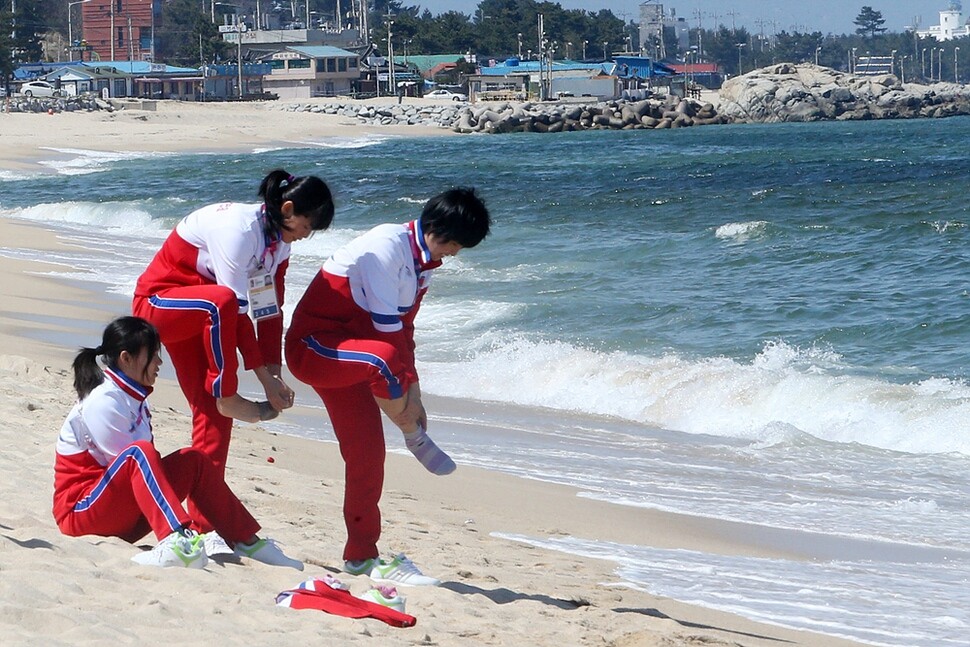 Members of the North Korean women’s ice hockey team walk along Gyeongpo Beach in Gangneung